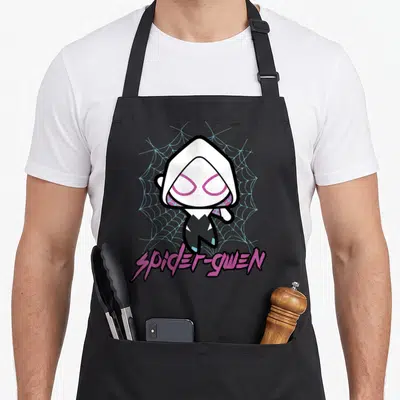Comic kawaii apron - Chibi Spider-Gwen character on light blue web with pink SPIDER-GWEN text below — shown on a black cotton canvas apron against a white background