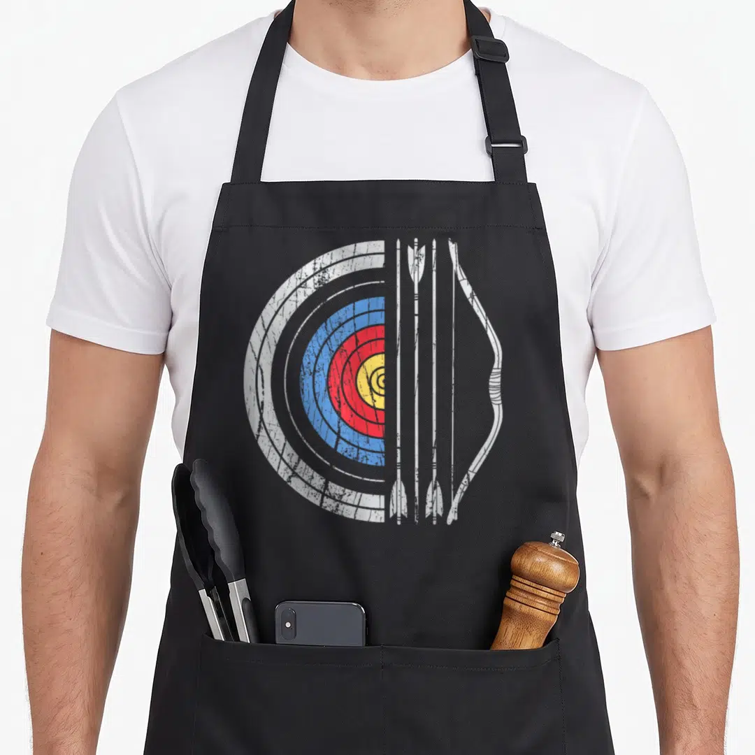 Arrow bow apron - Split archery target with two arrows and a bow in distressed white, blue, red, and yellow — shown on a black cotton canvas apron against a white background