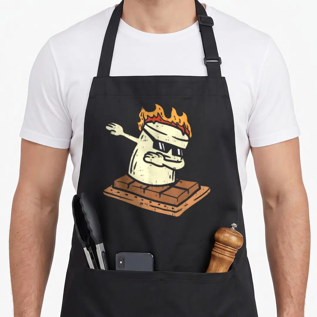Dabbing camping apron - Cartoon marshmallow with sunglasses and fire dabbing on a graham cracker — shown on a black cotton canvas apron against a white background