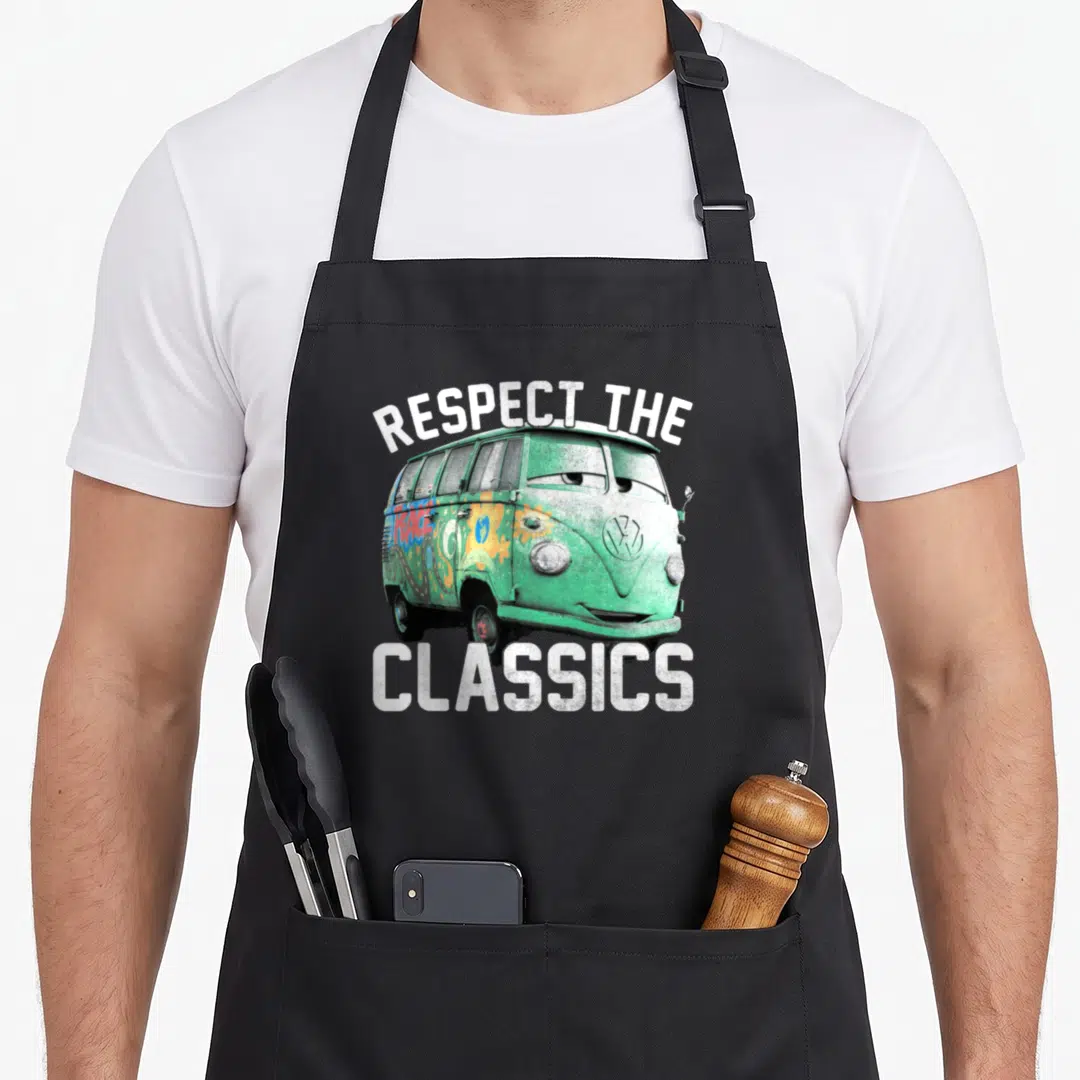 Fillmore cars apron - Green VW van illustration with Respect The Classics text in white — shown on a black cotton canvas apron against a white background