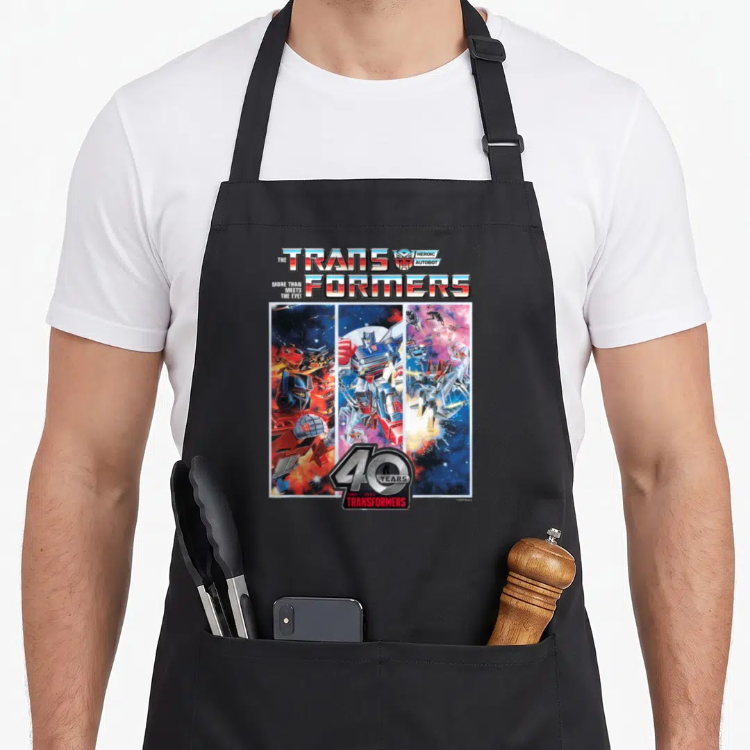 Autobot 40th apron - Three vertical Transformers robot panels with 40 Years 1984-2024 logo and Heroic Autobot text — shown on a black cotton canvas apron against a white background