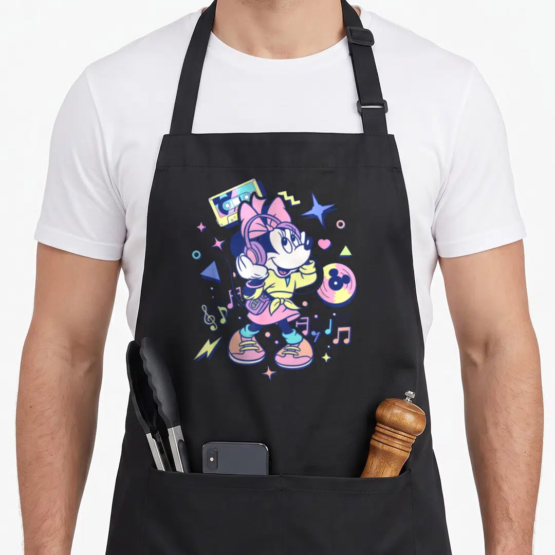 90s memphis apron - Cartoon Minnie Mouse with headphones, walkman, cassette, and record in pink yellow blue purple — shown on a black cotton canvas apron against a white background