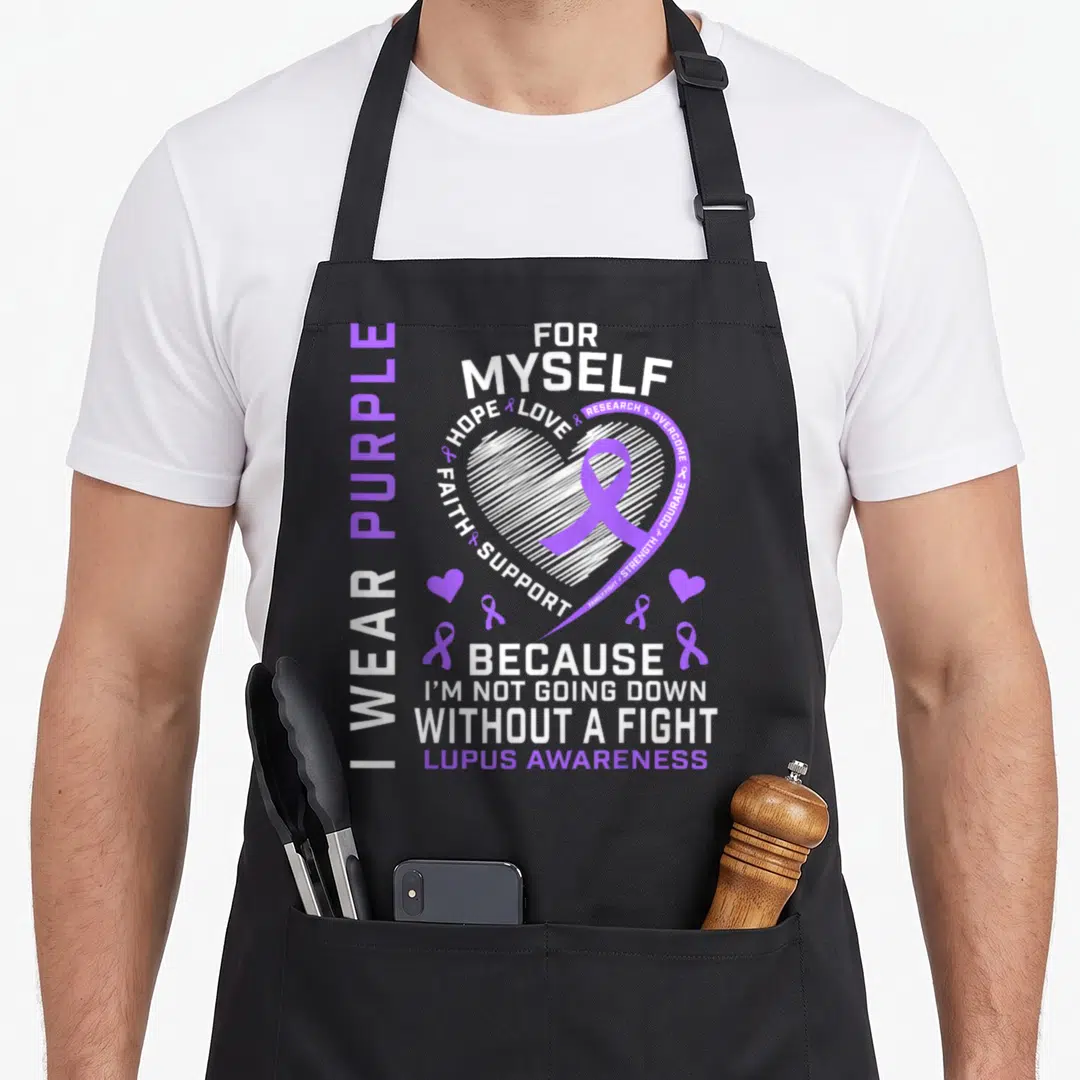 Myself lupus awareness apron - Purple and white typography design with a heart, ribbon, and words about lupus awareness — shown on a black cotton canvas apron against a white background
