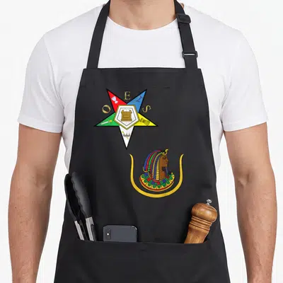 Oes split apron - Multicolored star with ESO letters and pharaoh profile in line art style — shown on a black cotton canvas apron against a white background