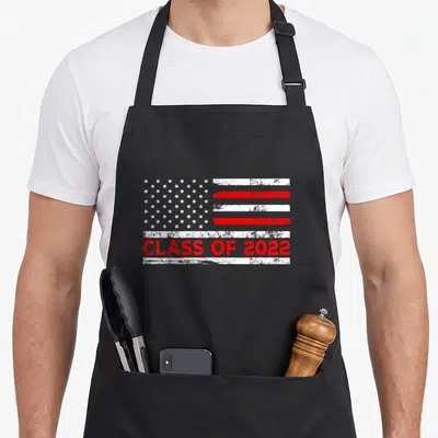 Future american flag apron - Distressed USA flag with red white stripes and CLASS OF 2022 text — shown on a black cotton canvas apron against a white background