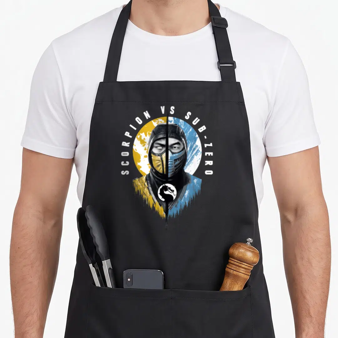 Klassic split apron - Split fighter face yellow blue SCORPION VS SUB-ZERO text arch dragon logo — shown on a black cotton canvas apron against a white background