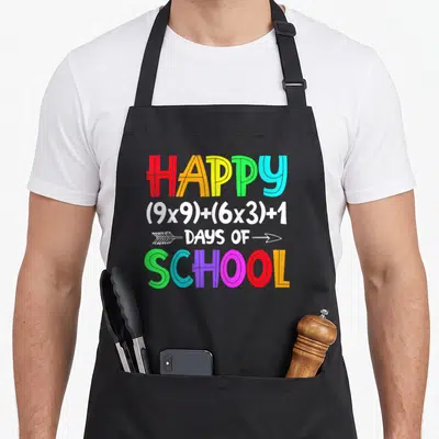 Math formula school 100th teacher apron - Rainbow text reading Happy 9x9 plus 6x3 plus 1 Days of School with white — shown on a black cotton canvas apron against a white background