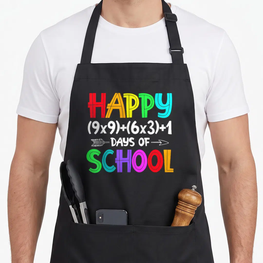 Math formula school 100th teacher apron - Rainbow text reading Happy 9x9 plus 6x3 plus 1 Days of School with white — shown on a black cotton canvas apron against a white background