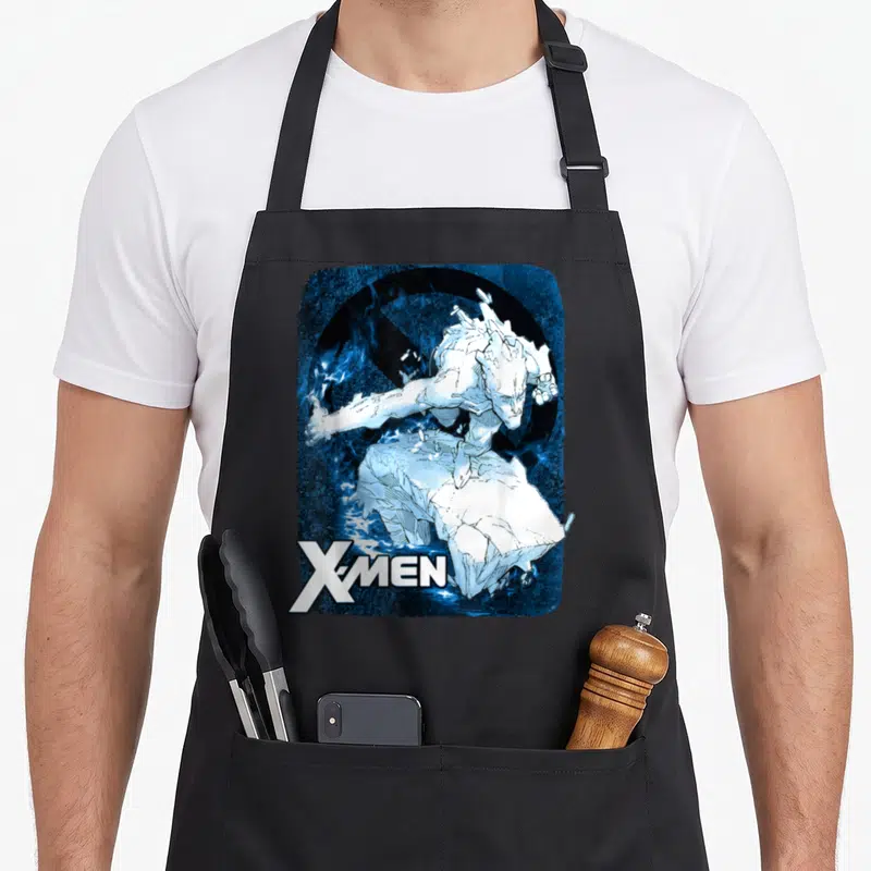 Iceman x apron - X-MEN logo next to white character perched on ice block with blue energy effects — shown on a black cotton canvas apron against a white background
