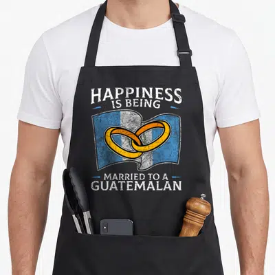 Marriage guatemalan aprons - Two interlocking gold rings over waving blue and white Guatemala flag with distressed — shown on a black cotton canvas apron against a white background