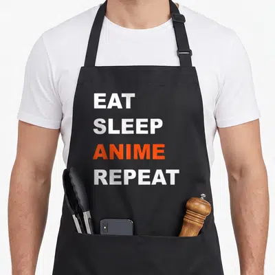 Repeat japanese anime apron - Stacked white and orange text reading EAT SLEEP ANIME REPEAT — shown on a black cotton canvas apron against a white background