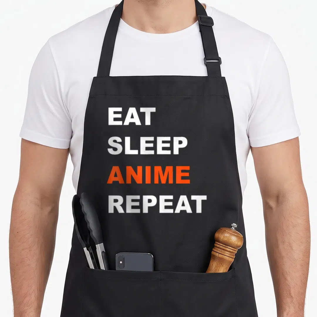 Repeat japanese anime apron - Stacked white and orange text reading EAT SLEEP ANIME REPEAT — shown on a black cotton canvas apron against a white background