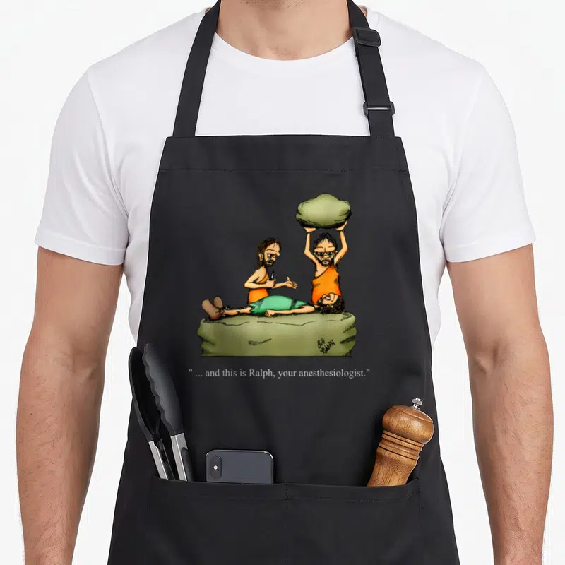 Caveman cartoon apron - Three cavemen on a slab, one holds a rock, caption reads and this is Ralph your anesthesiologist — shown on a black cotton canvas apron against a white background