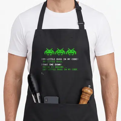 Bug engineer apron - Three green pixel bugs above white and green code text reading 99 little bugs in my code — shown on a black cotton canvas apron against a white background