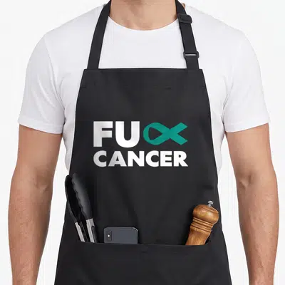 Ovarian funk apron - White FU CANCER text with teal ribbon forming CK letter — shown on a black cotton canvas apron against a white background