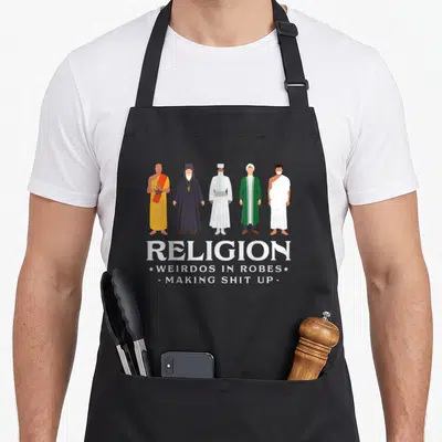 Weirdo agnostic apron - Five cartoon religious figures in robes above white text reading RELIGION WEIRDOS IN ROBES — shown on a black cotton canvas apron against a white background