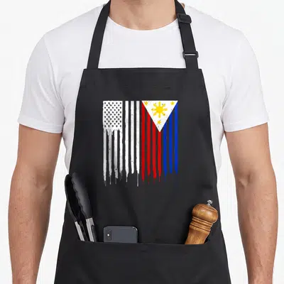 Cute filipino american flag apron - Merged US and Philippine flags with dripping paint, distressed red white blue yellow — shown on a black cotton canvas apron against a white background