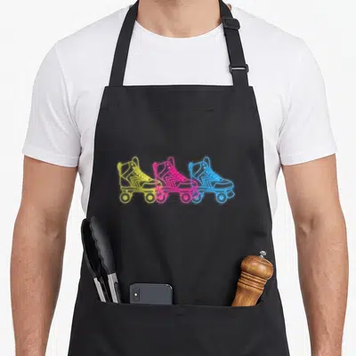 Skating 80s apron - Three neon roller skates in yellow, pink, and blue line art — shown on a black cotton canvas apron against a white background