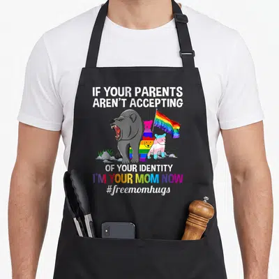 Parent bear mom apron - Four cartoon bears including a large grey one holding a rainbow flag under white and rainbow — shown on a black cotton canvas apron against a white background