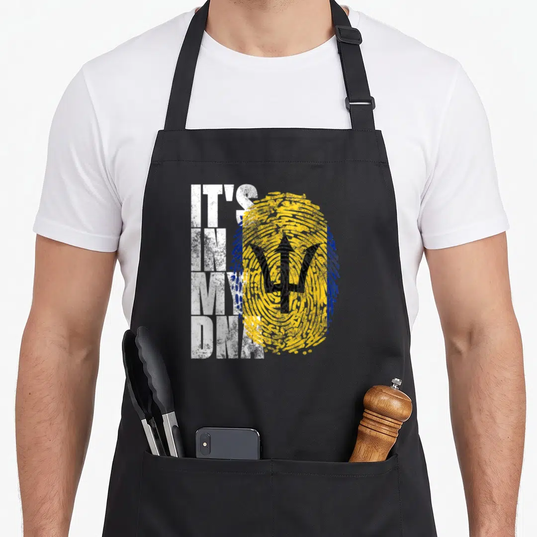 Dna barbados apron - White IT'S IN MY DNA text beside gold blue fingerprint with black trident symbol — shown on a black cotton canvas apron against a white background