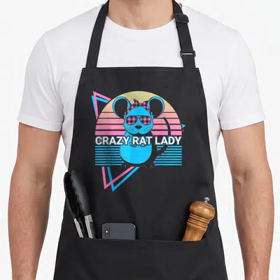 Funny mouse crazy rat lady apron - Blue rat with sunglasses and plaid bow in front of yellow pink striped circle — shown on a black cotton canvas apron against a white background