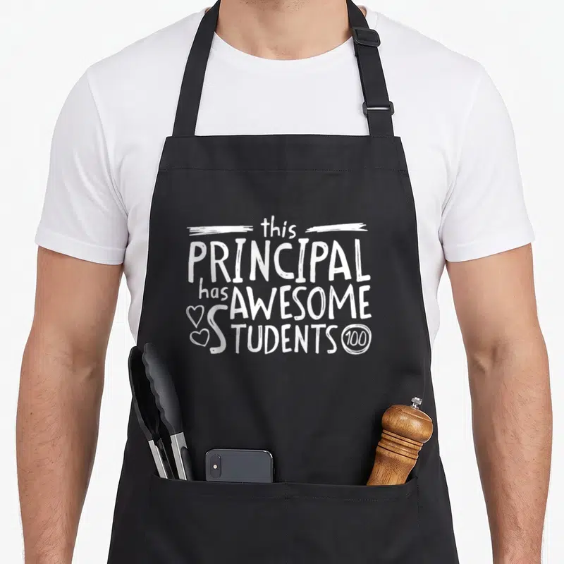 School principal student aprons - White stacked text reading Principal has Awesome Students with two hearts and circled — shown on a black cotton canvas apron against a white background