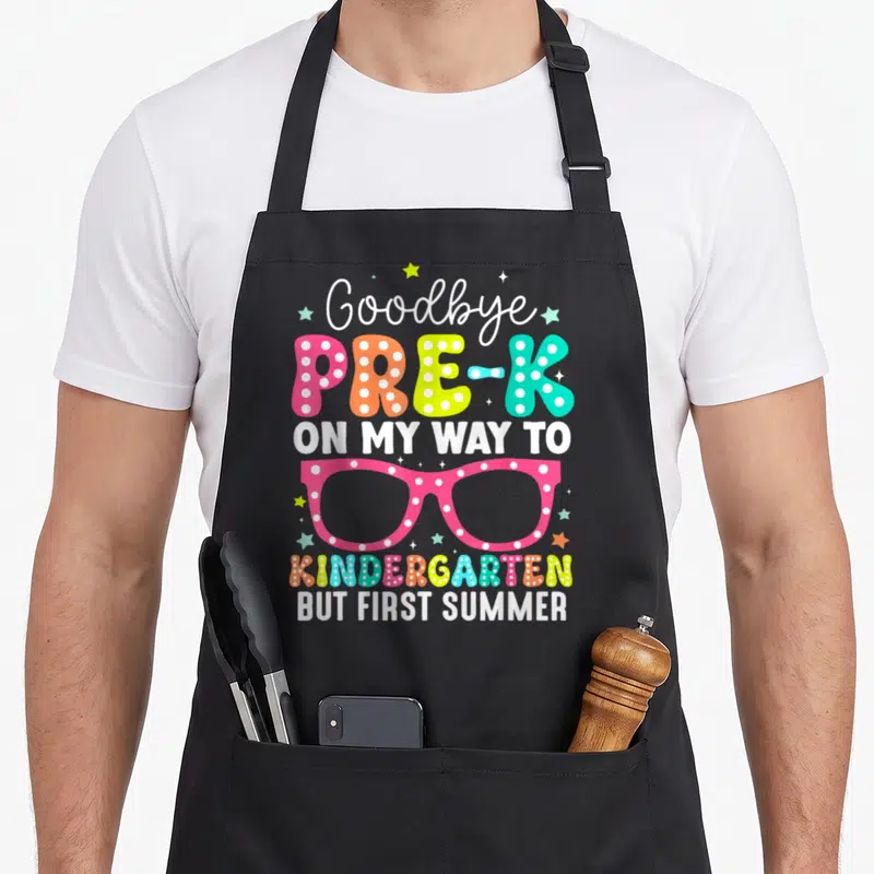 Pre summer aprons - Stacked text reading Goodbye Pre-K On My Way To Kindergarten But First Summer with polka dot — shown on a black cotton canvas apron against a white background