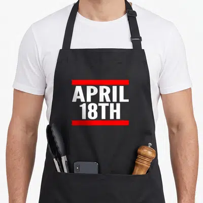 18th april apron - White text APRIL 18TH between two red horizontal bars — shown on a black cotton canvas apron against a white background
