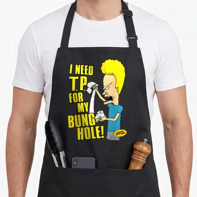 Beavis dad mode apron - Beavis holding toilet paper with stacked yellow text I NEED T.P. FOR MY BUNG-HOLE — shown on a black cotton canvas apron against a white background