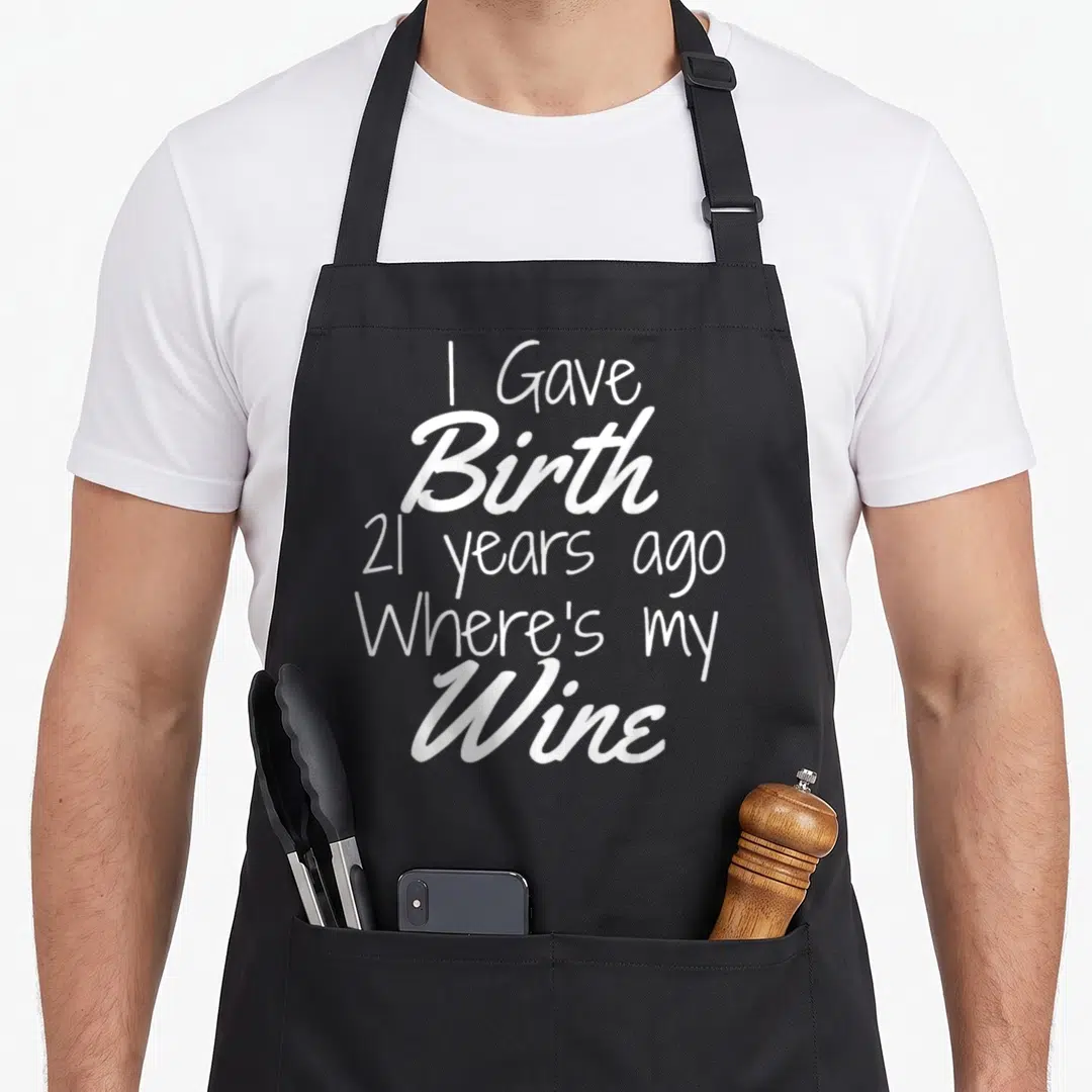 21st wine aprons - White stacked text reading I Gave Birth 21 Years Ago Where's my Wine — shown on a black cotton canvas apron against a white background