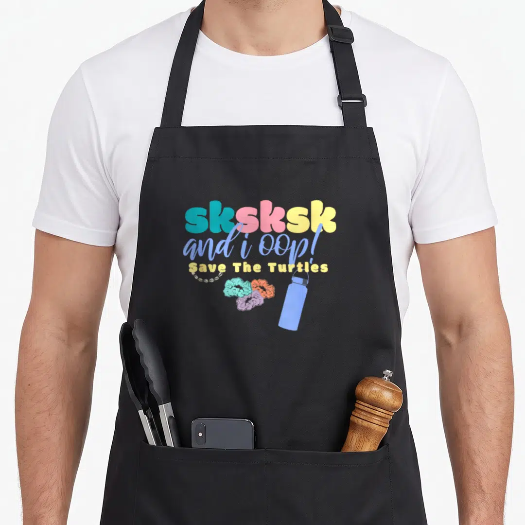Oop scrunchie apron - Stacked sksksk and i oop text with Save The Turtles, three scrunchies, chain, and water bottle — shown on a black cotton canvas apron against a white background