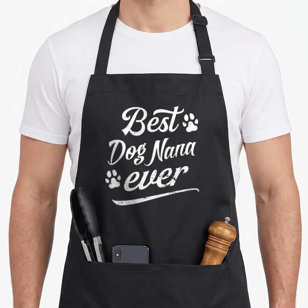 Father nana aprons - White distressed text Best Dog Nana ever with two paw prints and swoosh underline — shown on a black cotton canvas apron against a white background