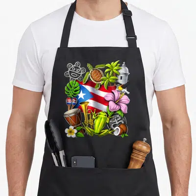 Taino frog aprons - Waving flag, coqui frog, Taino petroglyph, maracas, hibiscus, turtle, trumpet — shown on a black cotton canvas apron against a white background