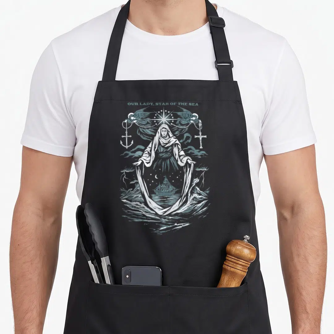 Our sea apron - Our Lady Star of the Sea line art with Virgin Mary, angels, anchor, cross, and ship on waves — shown on a black cotton canvas apron against a white background