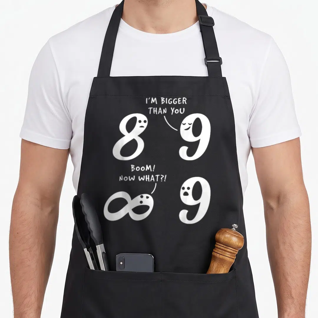 Mathematic joke bbq aprons - White numbers 8 and 9 with speech bubbles and infinity symbol in two comic scenes — shown on a black cotton canvas apron against a white background