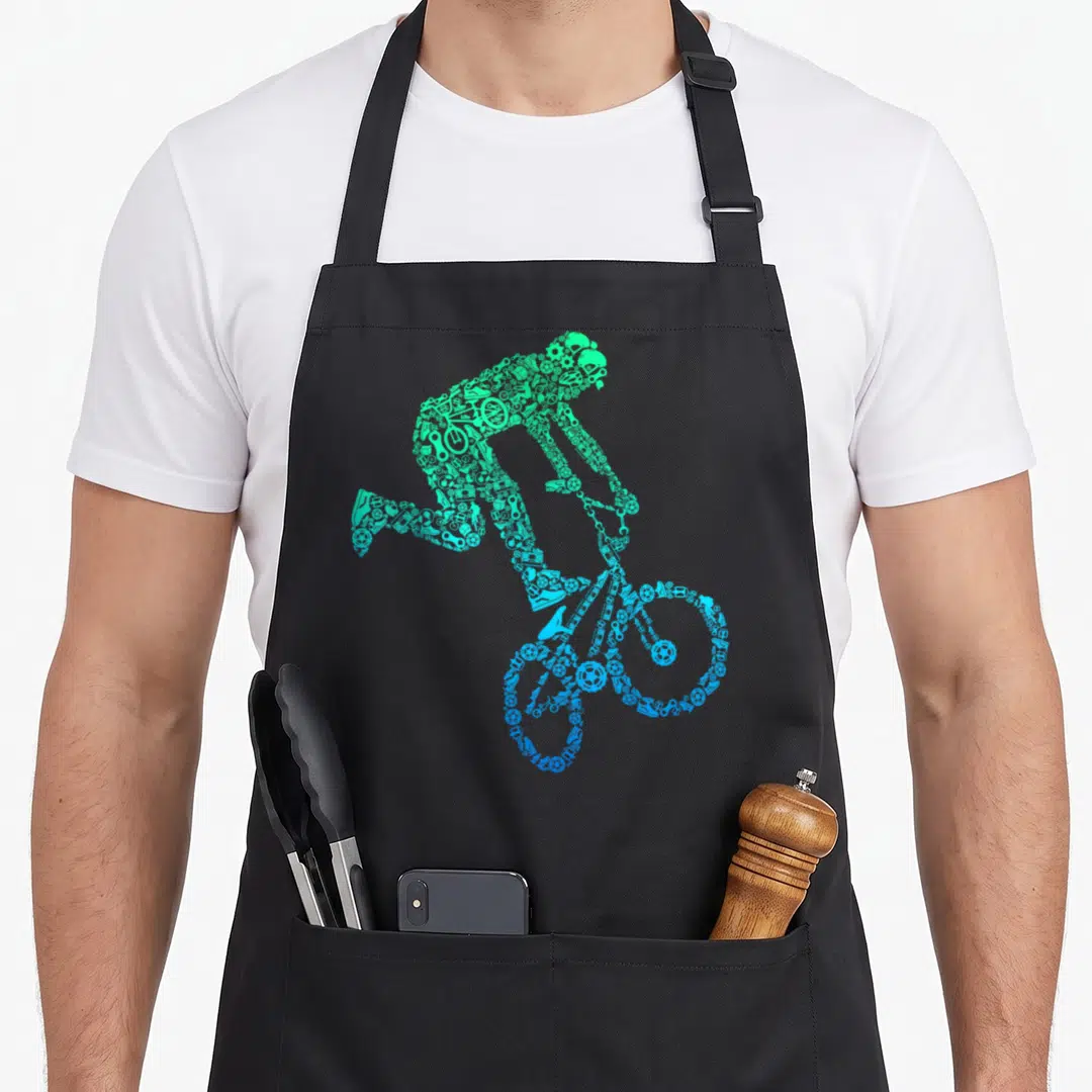 Rider bicycle bike apron - Cyclist silhouette made of green cyan and blue bicycle icons on black background — shown on a black cotton canvas apron against a white background