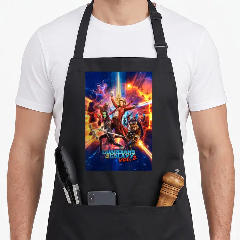 Studio guardian galaxy apron - Guardians of the Galaxy Vol 2 movie poster with characters in blue orange red yellow — shown on a black cotton canvas apron against a white background