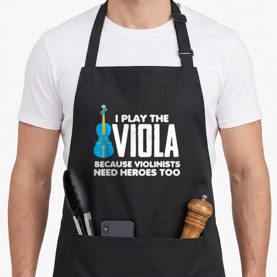 Play musical apron - Blue viola graphic beside white text reading I play the viola because violinists need heroes too — shown on a black cotton canvas apron against a white background