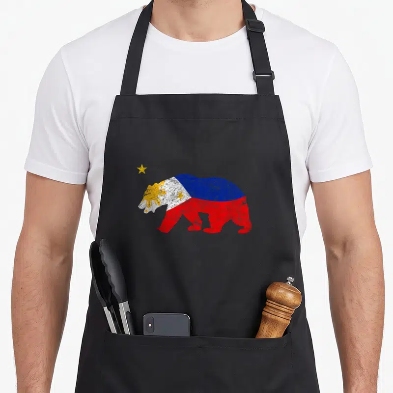 California charlottesville apron - Bear silhouette filled with Philippine flag pattern and floating yellow star — shown on a black cotton canvas apron against a white background
