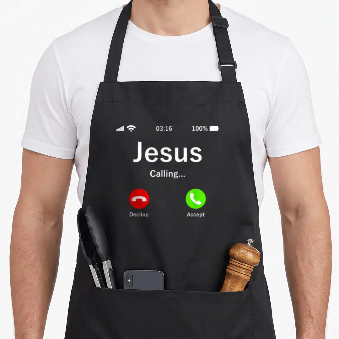 Calling christian apron - Grey smartphone screen graphic with Jesus calling text and red and green call buttons — shown on a black cotton canvas apron against a white background