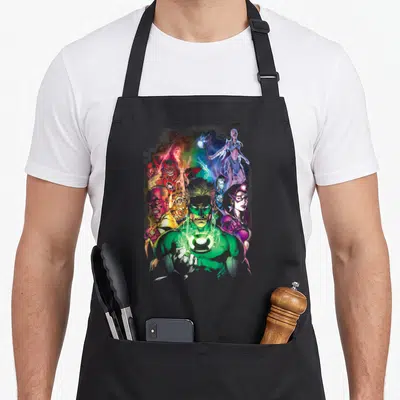 Lantern geek apron - Green Lantern central figure surrounded by Lanterns in green, red, blue, yellow, and violet radial — shown on a black cotton canvas apron against a white background