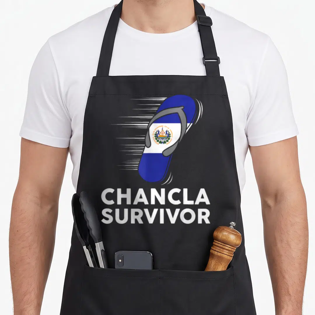 Chancla salvadoran apron - Flying blue white grey flip flop with El Salvador flag and Chancla Survivor text — shown on a black cotton canvas apron against a white background