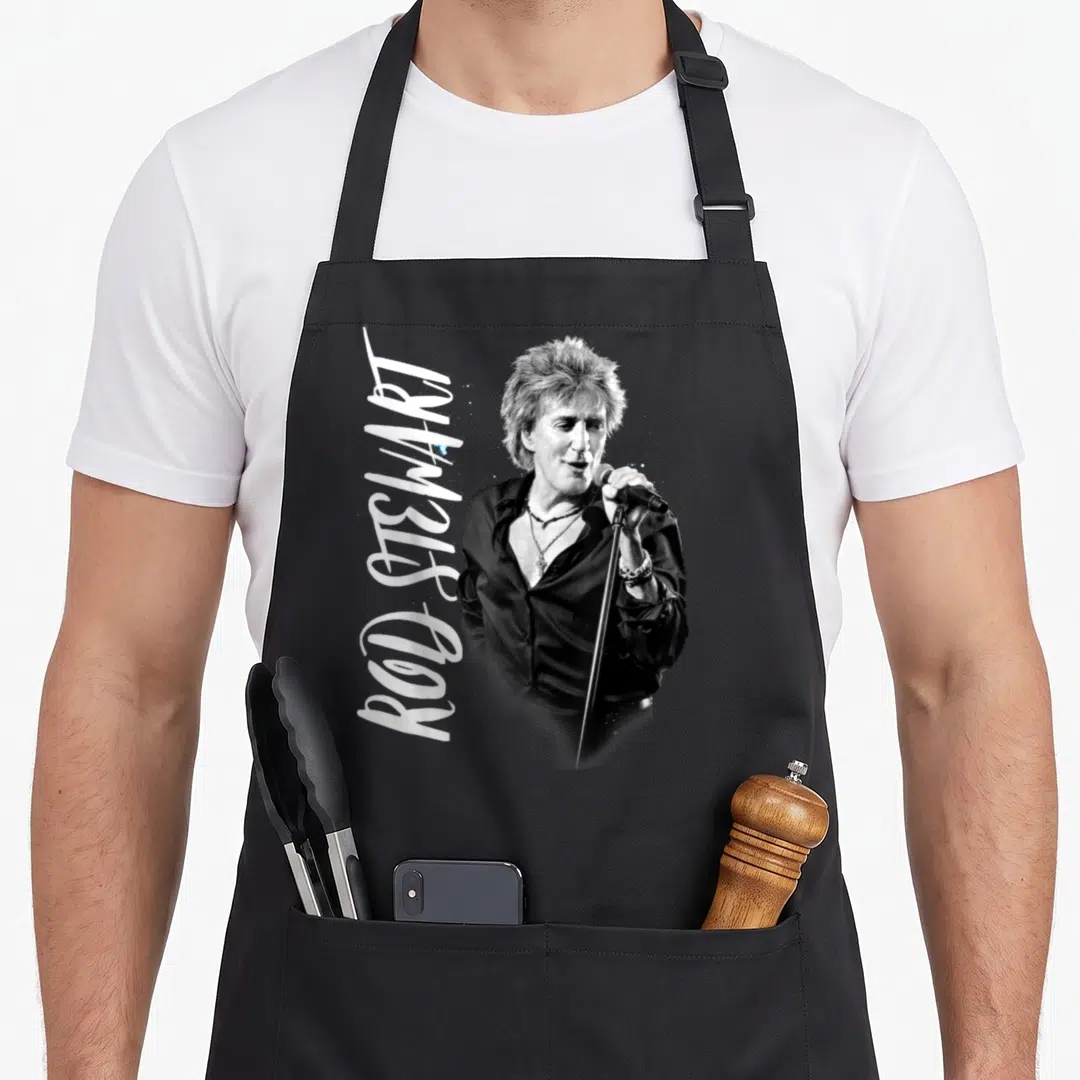 Admat rod apron - Black and white photo of singer holding microphone with vertical name script — shown on a black cotton canvas apron against a white background