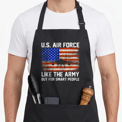 Air smart apron - Grey fighter jet on distressed US flag with U.S. Air Force text — shown on a black cotton canvas apron against a white background
