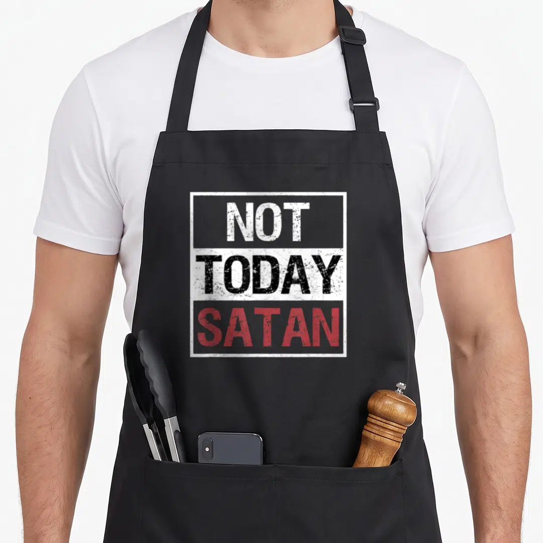 Satan christian apron - Stacked distressed text reading NOT TODAY SATAN in white black and red inside a white border — shown on a black cotton canvas apron against a white background