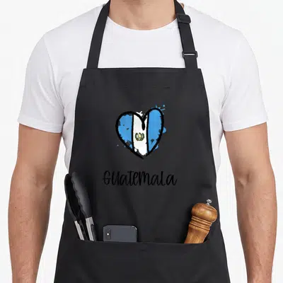 Guatemala spanish aprons - Heart filled with blue white and black flag colors above Guatemala text — shown on a black cotton canvas apron against a white background
