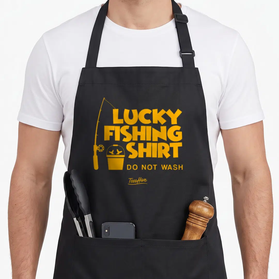 Lucky fishing aprons - Yellow lucky fishing shirt do not wash text with rod and fish bucket icon — shown on a black cotton canvas apron against a white background