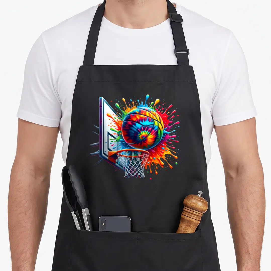 Basketball tie dye apron - Tie-dye basketball exploding with blue red yellow green orange paint near a hoop and net — shown on a black cotton canvas apron against a white background