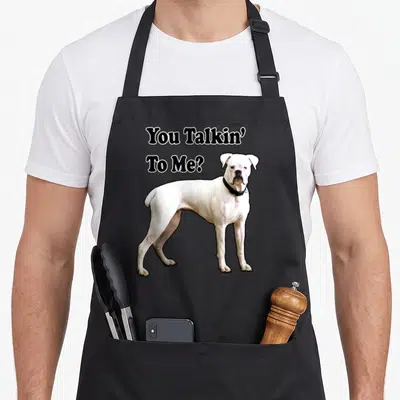 Talkin boxer dog apron - You Talkin To Me text above a standing white boxer dog photo — shown on a black cotton canvas apron against a white background