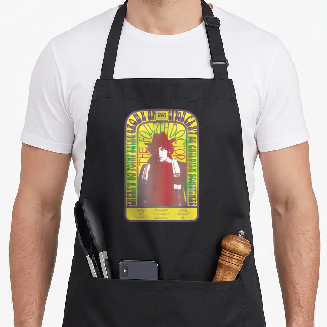Spacetime baker apron - Fourth Doctor portrait in yellow purple green red arch with quote about childishness — shown on a black cotton canvas apron against a white background